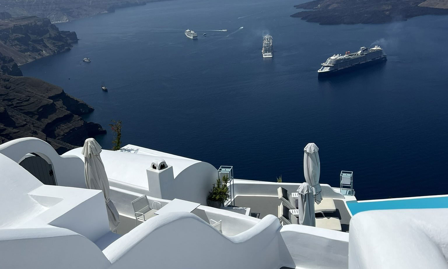 Cruise ships anchored in the Santorini caldera seen from the cliff above the Old Port