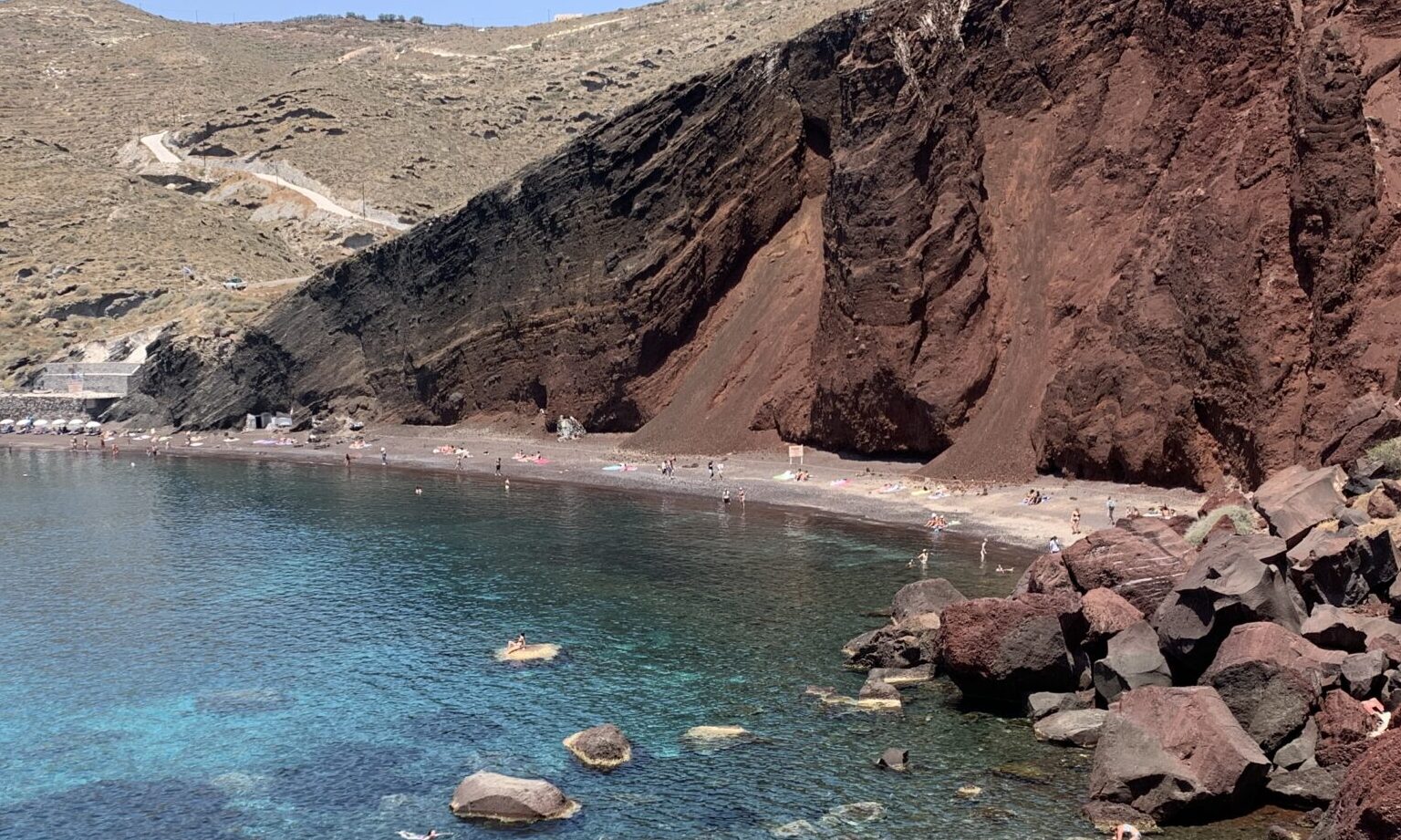 Red Beach Santorini with dramatic volcanic red cliffs and blue Aegean Sea